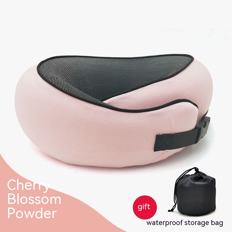 Pink, crescent-shaped cervical neck pillow with black mesh center, adjustable buckle strap, and black storage bag.