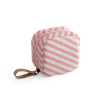 Small, square makeup bag with pink and white diagonal stripes, a zipper closure, and a tan leather-look wrist strap.