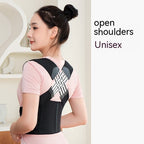 Woman wearing a black posture corrector brace over a pink shirt, featuring an X-shaped back support design.