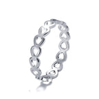 Silver-tone metal ring featuring a continuous band of connected, open-work heart shapes on a white background.