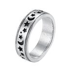 Silver-tone ring with a blackened engraved pattern of stars, crescents, and dots in a street-style design.