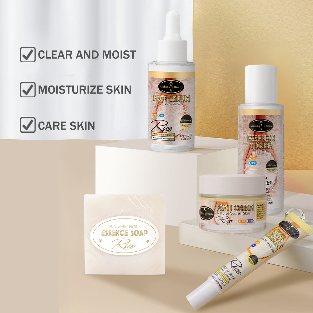Aichun Beauty rice skincare set including serum, toner, face cream, eye cream, and soap on white pedestals.