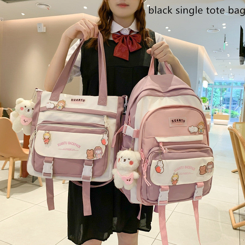 Person holding a pink and white Korean-style backpack and tote set with cute character pins and a fuzzy bear keychain.