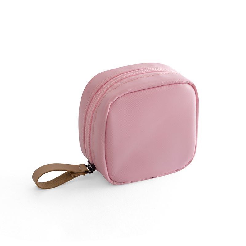 Small square pink fabric makeup bag with a zipper closure and a tan leather-look handle on a white background.