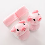 White and pink baby socks with plush 3D piggy faces on the toes. Soft knit material with cozy pink ribbed cuffs.
