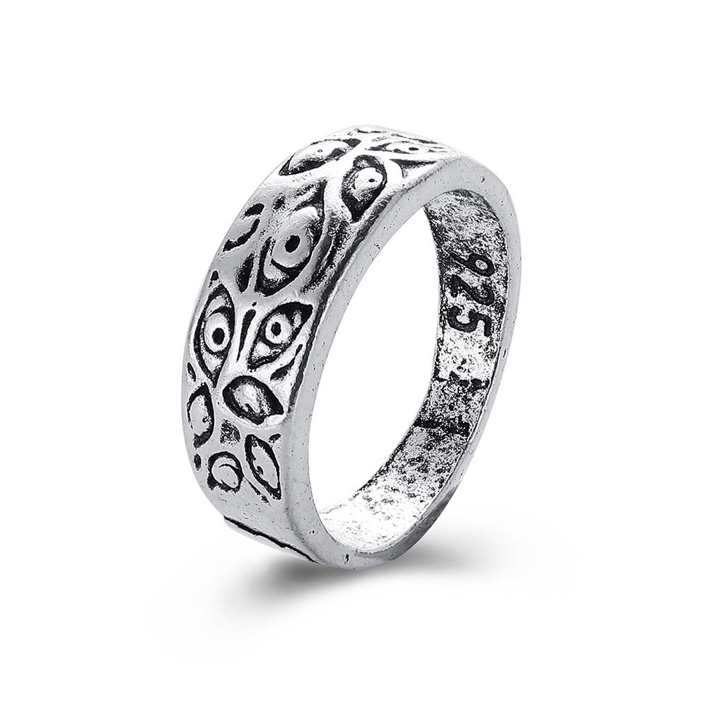 Silver-toned hip hop ring with an engraved, repeating evil eye pattern and "925" stamped on the inner band.