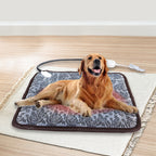 Golden retriever resting on a gray, floral-patterned electric pet heating pad with a chew-resistant cord.