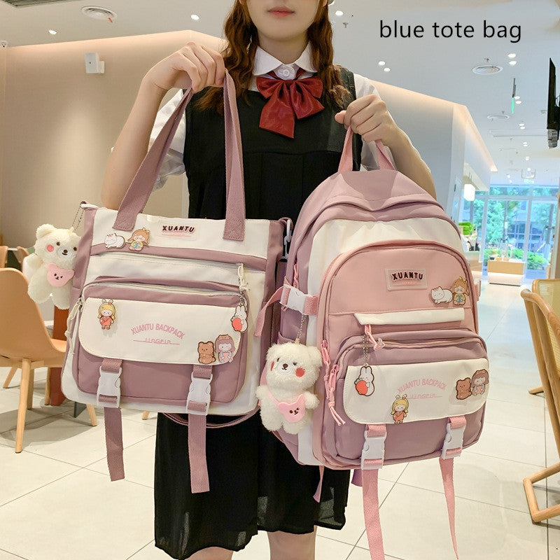 Person holding a pink and white Korean-style backpack and matching tote bag with cute animal charms and Xuantu branding.