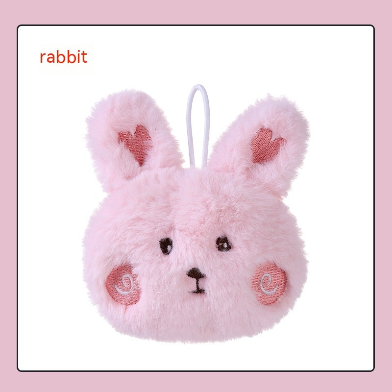 Pink plush rabbit hand warmer with heart-detailed ears, embroidered face, rosy cheeks, and a white hanging loop.