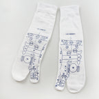 Pair of white cotton reflexology socks featuring printed blue acupressure point diagrams and toe-separator design.