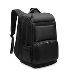 Sleek black, minimalist multifunctional backpack with multiple zippered compartments and padded shoulder straps.
