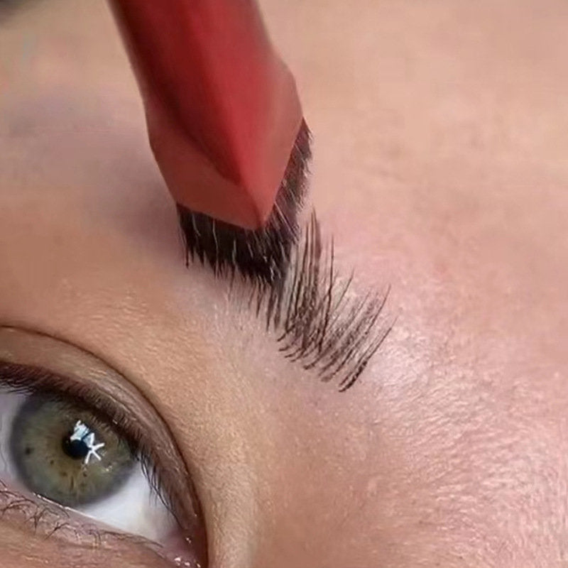 A thin, angled makeup brush with black bristles creating precise, hair-like strokes on skin near an eye.