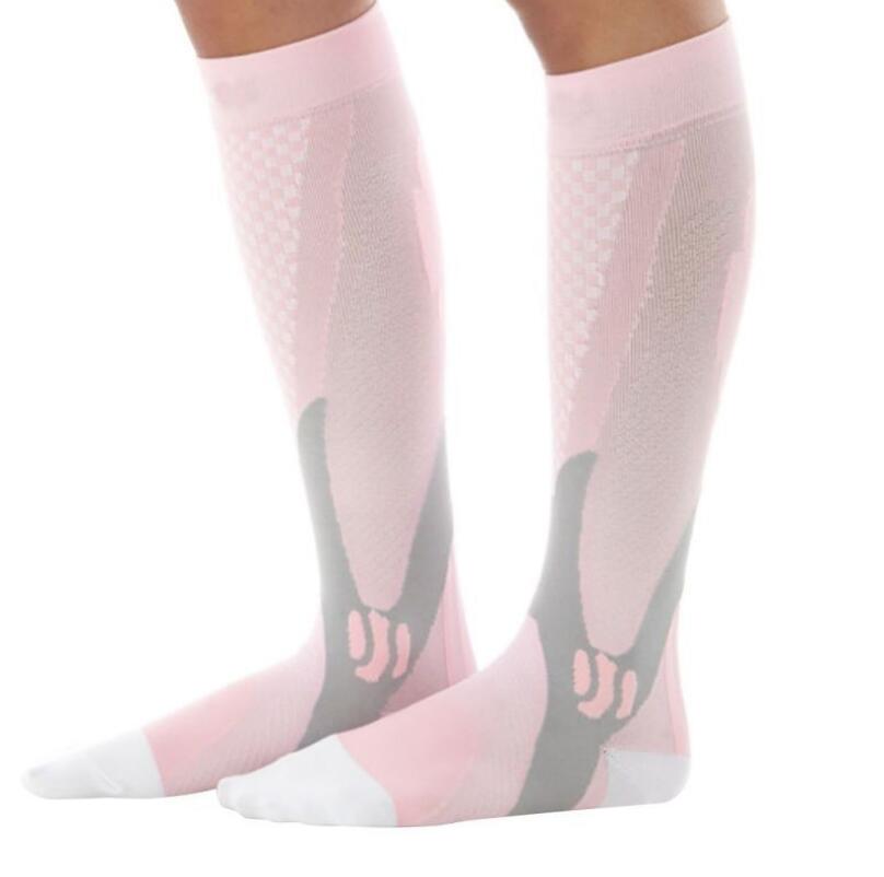 Light pink, knee-high compression socks with white toes and gray support patterns on feet and calves, white background.