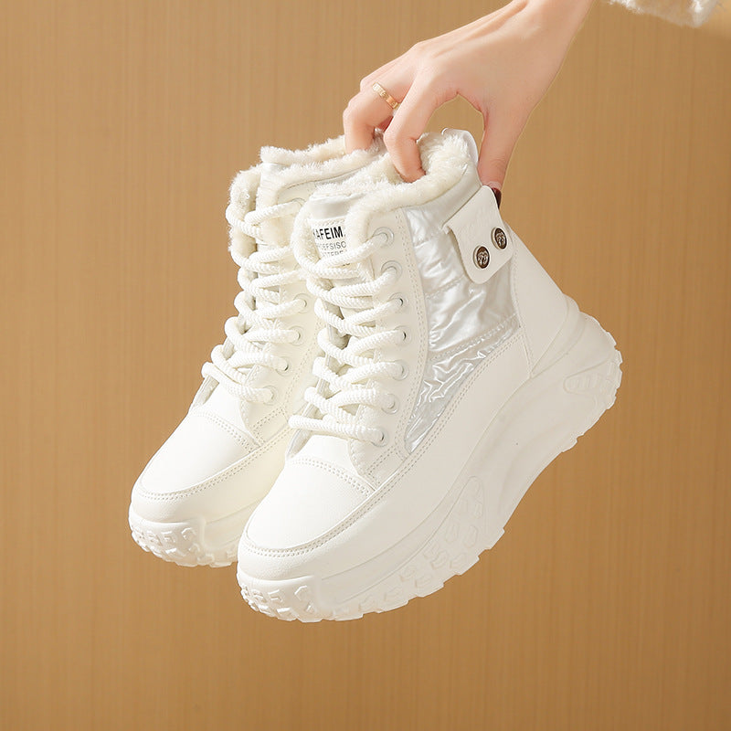 White, fleece-lined, high-top windproof sneakers with lace-up closure, chunky platform soles, and side snap details.