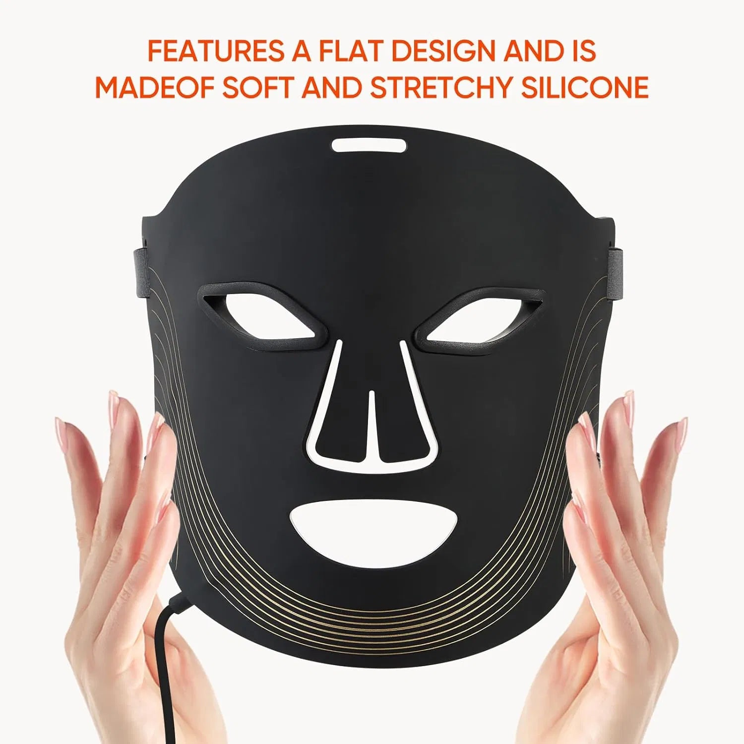 Black, flat, flexible silicone 7-color LED face mask with eye and mouth cutouts, held by hands against white background.
