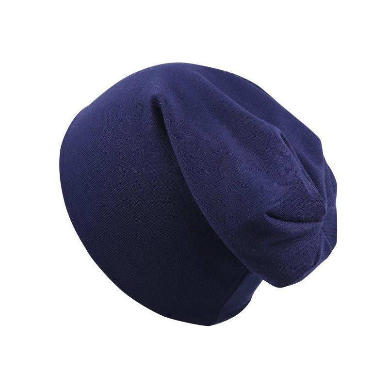 Simple navy blue newborn beanie cap made of soft, stretchy knit fabric in a classic slouchy hexagon style.