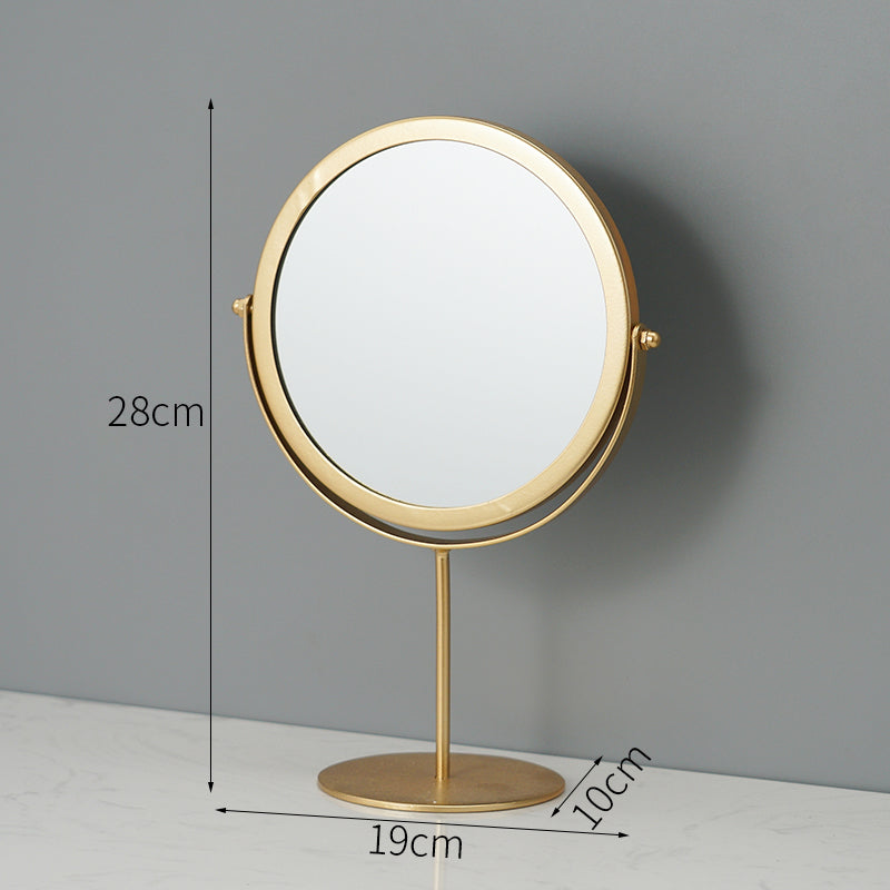 Round gold metal tabletop makeup mirror with a swivel frame, standing 28cm tall on a circular base.