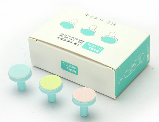 Three colorful, textured baby nail trimmer replacement heads placed in front of their branded packaging box.