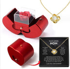 Red apple-shaped gift box containing an artificial red rose, paired with a gold knot pendant necklace and gift card.