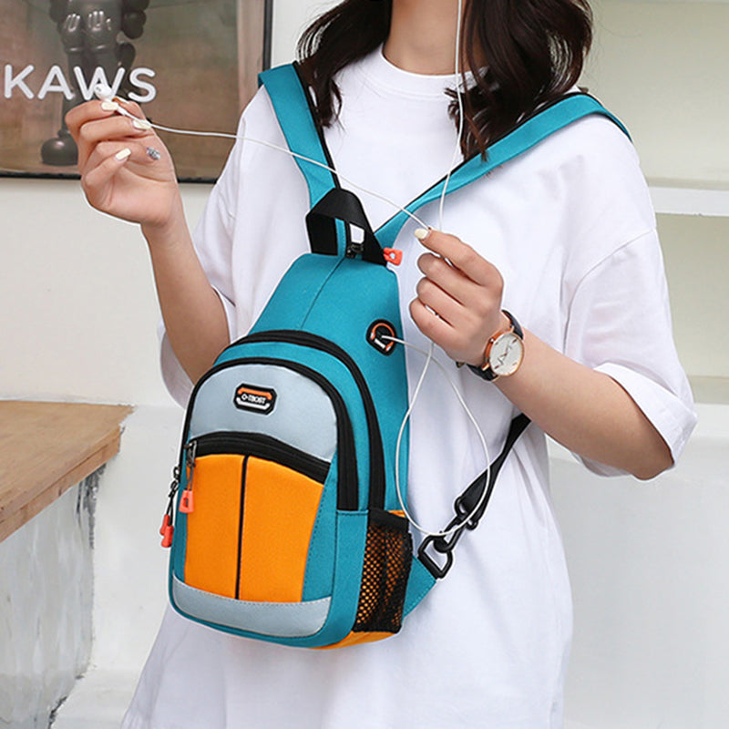 A woman wearing a teal and orange multifunctional backpack with a USB port and side mesh pocket.