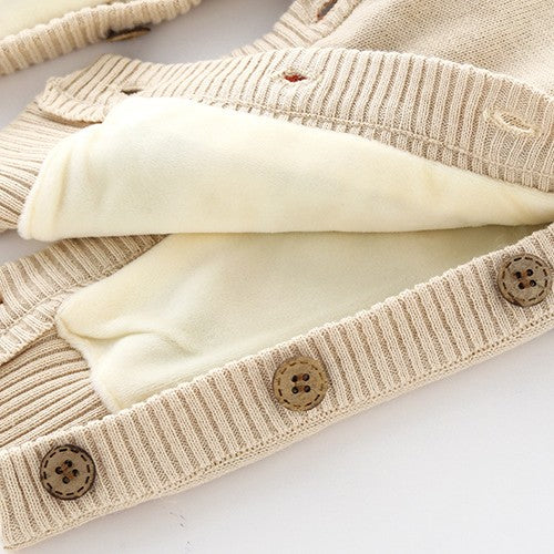 Beige ribbed knit newborn onesie with thick, soft cream fleece lining and wooden buttons.