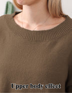 A woman wearing a brown, long-sleeved knit sweater with a ribbed crew neckline. Close-up upper body view.