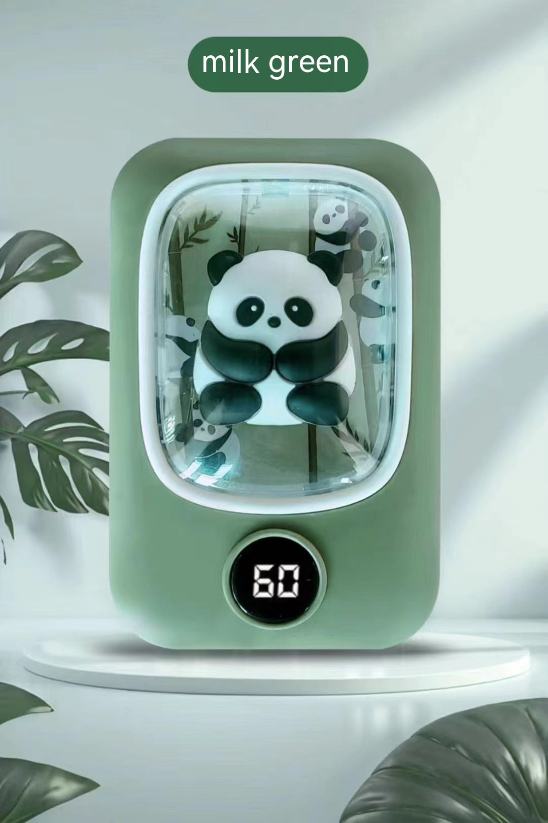 Milk green, rectangular panda hand warmer with a digital temperature display and a clear window showing panda figures.