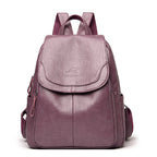 A purple soft leather casual backpack with a flap top, kangaroo logo, and matching fabric shoulder straps.