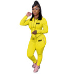 A woman wearing a bright yellow, long-sleeved zip-up hoodie and matching leggings, both printed with "BODY" text.