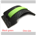 Black and green arched lumbar stretcher featuring a textured plastic base and a soft foam spine support pad.