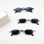 Three pairs of slim, rectangular vintage-style sunglasses in black, gold, and silver metal frames on white background.