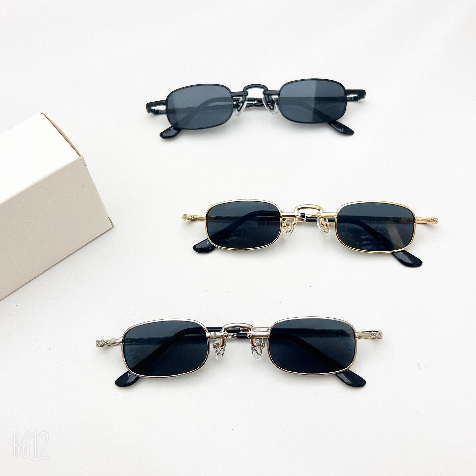 Three pairs of slim, rectangular vintage-style sunglasses in black, gold, and silver metal frames on white background.