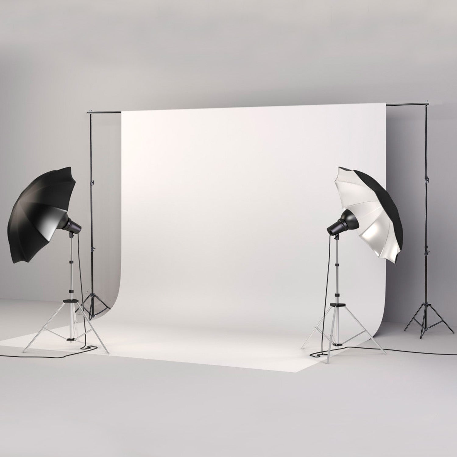 Studio backdrop stand set with white background, black and silver lighting umbrellas, and metal tripod stands.