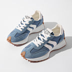 Blue and white lace-up sneakers with suede overlays, chunky white soles, gum tread, and "STAY REAL" tongue labels.