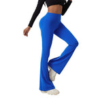 Model wearing vibrant royal blue, high-waisted, hip-lifting, wide-leg fitness pants in stretchy athletic fabric.