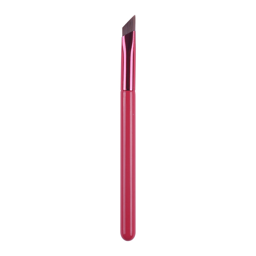 An angled, flat-tipped makeup brush with a vibrant hot pink handle and ferrule against a clean white background.