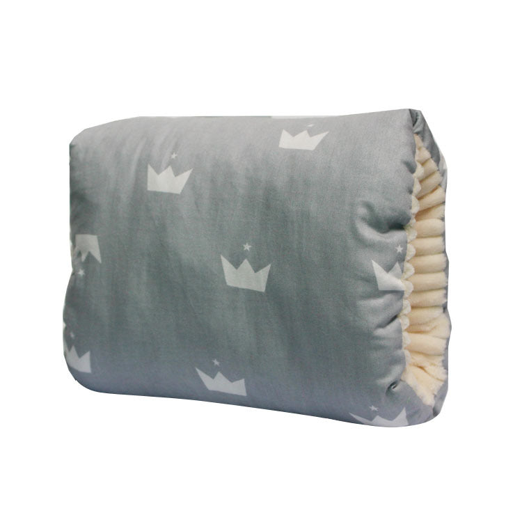Grey cotton baby nursing arm pillow with white crown pattern and soft cream-colored interior lining.