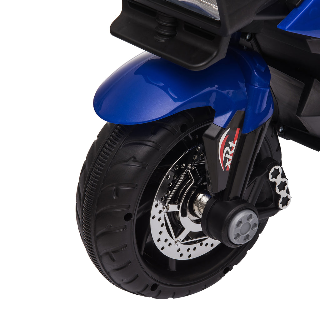 Close-up of a blue kids' electric motorcycle front wheel with black treaded tire, chrome-look disc, and xRt decal.