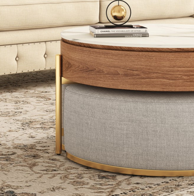 Round wood-and-marble lift-top coffee table with gold frame and nesting gray fabric stools.