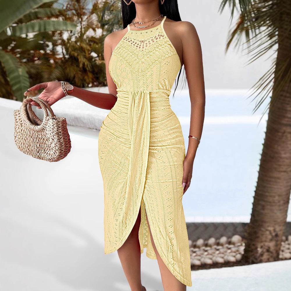 Pale yellow sleeveless halter midi dress in textured crochet lace with an asymmetric front-wrap skirt design.