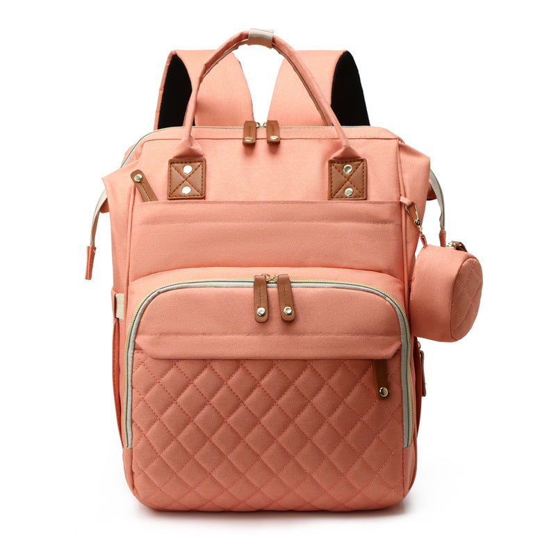 Peach-colored quilted mummy backpack by Digitaldistribution375 with top handles, USB port, and a matching side pouch.