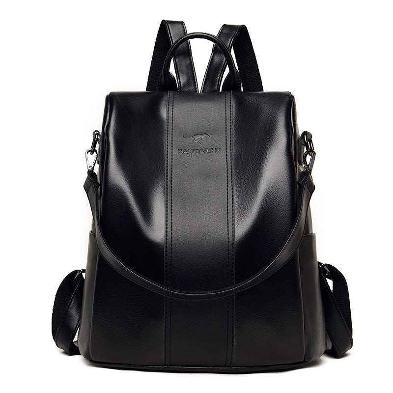 Black soft leather women’s backpack with a kangaroo logo, top handle, and adjustable shoulder straps on white.