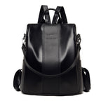 Black soft leather women’s backpack with a kangaroo logo, top handle, and adjustable shoulder straps on white.