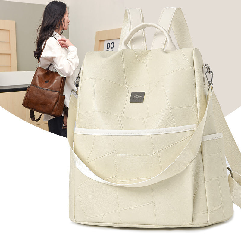 Minimalist beige patchwork backpack by Digitaldistribution375 with top handle, adjustable straps, and metal branding.