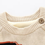 Beige knit newborn sweater featuring a ribbed collar, wood-look button detail, and soft fleece lining.