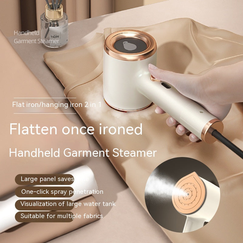 A handheld, cream and gold portable garment steamer being used on tan fabric, featuring a sleek, modern design.