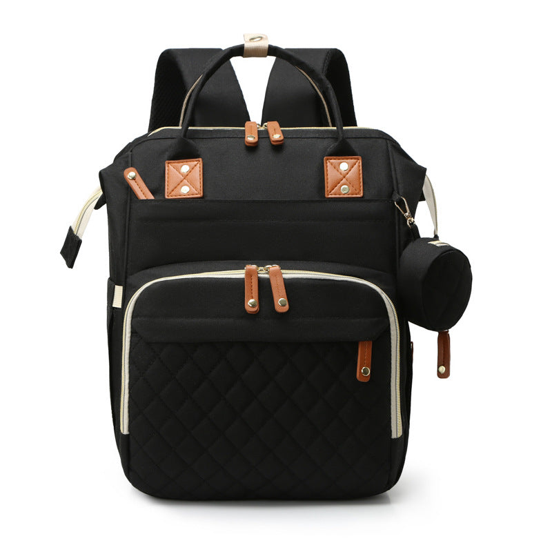 Black quilted mummy backpack with brown accents, multiple zippered compartments, top handles, and side accessory pouch.
