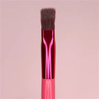 Squared-off eyebrow makeup brush with brown synthetic bristles, a shiny magenta metal ferrule, and a pink handle.