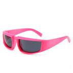 Hot pink, chunky plastic cycling sunglasses featuring a futuristic wraparound frame and dark grey tinted lenses.