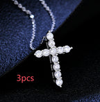 A silver-toned chain necklace featuring a cross pendant encrusted with sparkling clear round-cut faux diamonds.